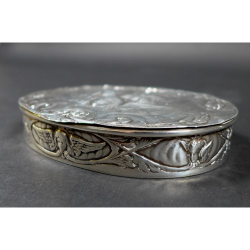 4A - An Edwardian silver box, of oval section with hinged cover, repousse decorated with a 'Reynolds Ange... 