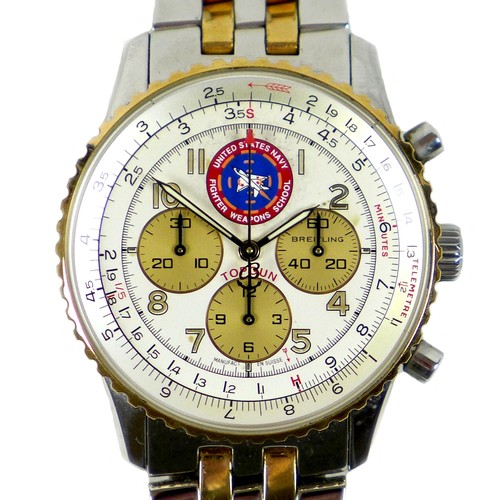 A Breitling Navitimer 'TOPGUN' stainless steel cased gentleman's wristwatch, ref. D30022, circa 1995, circular silvered dial with three contrast sub chronograph dials, tachymetric scales, stopwatch function, and with the logo of TOPGUN - The United States Navy Fighter Weapons School, luminous Arabic numerals, luminous hands, gold bezel, screw down case back with relief markings, on Breitling branded stainless steel and gold plated bracelet strap with deployment clasp, stamped 'Navi 92' and '12695', produced in a limited edition of 1000, this example is number 0269, 39mm case, 123.2g gross, with bakelite style hard case (damaged), various original papers, and branded outer box.
Notes: in good working condition, winds and hands set well, keeps time across 1hr test, all functions appear to work well, however Batemans cannot guarantee its continued operation.