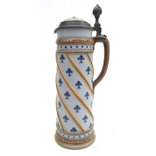 23 - A German 'Mettlach' pottery beer stein, decorated with fleur-de-lis on a pale blue ground, with meta... 