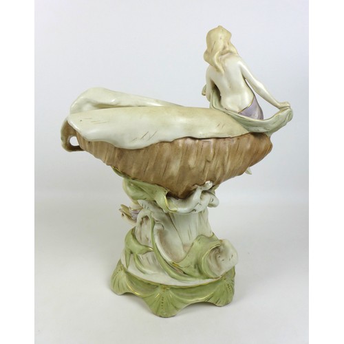47 - A Dux ceramic centrepiece, formed as a conch shell with two classical ladies draped beside it, a/f d... 