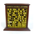An Edwardian mahogany table top cabinet, advertising interest, for 'Cash's Double Letters', containi... 