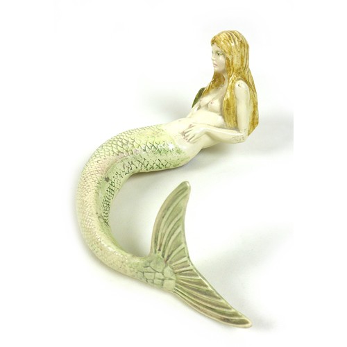 25 - A modern pottery sculpture, modelled as a mermaid, a/f her right arm missing / repaired, 26 by 21 by... 