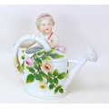 A group of eight collectables and ceramics, including a Meissen style vase in the style of a Putti w... 