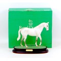 A Royal Doulton figurine of the racehorse Desert Orchid, raised upon a wooden plinth, 27 by 12 by 22... 