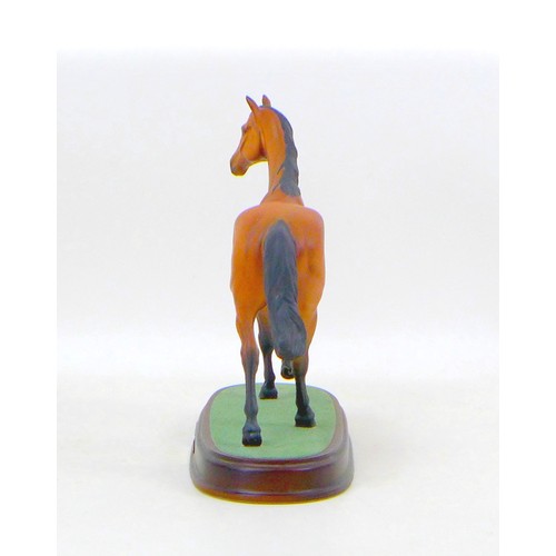 39 - A Royal Doulton figurine of the racing horse Red Rum, raised upon a wooden plinth, 25.5 by 10.5 by 2... 