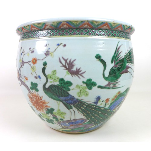 5 - A Chinese porcelain Famille Verte fish bowl, decorated in Kangxi style with two peacocks amongst tre... 