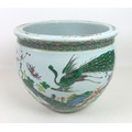 A Chinese porcelain Famille Verte fish bowl, decorated in Kangxi style with two peacocks amongst tre... 