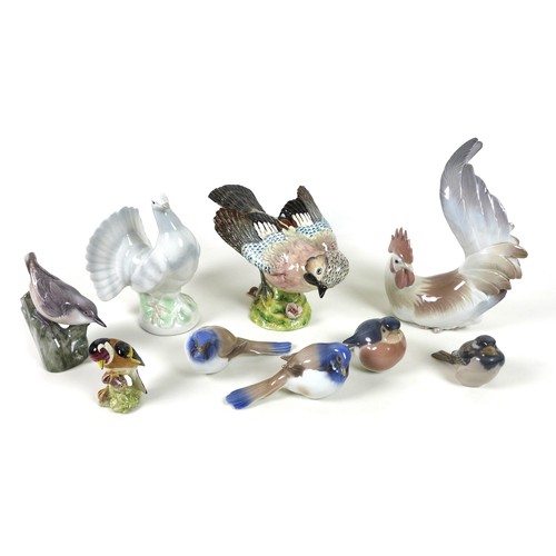 37 - A group of nine ceramic figurines, all modelled as birds, comprising a Beswick 'Jay', model 1219, im... 