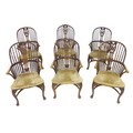 A set of six oak Windsor armchairs, mid 20th century, each with a pierced wheat and floral decorated... 