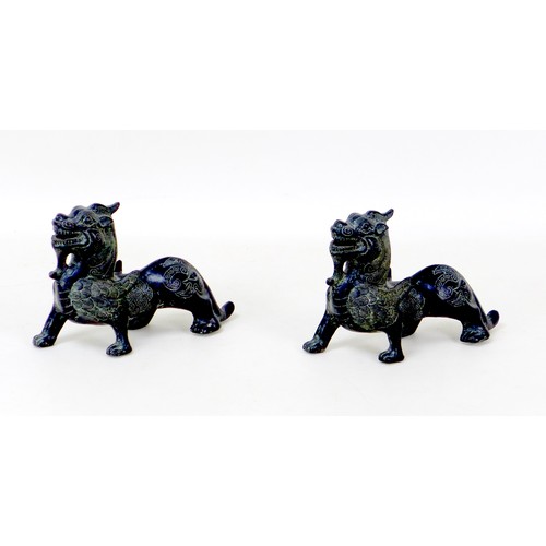 3 - A pair of early 20th century Chinese cast bronze griffins, unsigned, with engraved decoration, 19 by... 