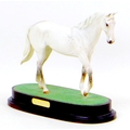 A Royal Doulton figurine of the racehorse Desert Orchid, raised upon a wooden plinth, 27 by 12 by 22... 