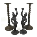 Two pairs of decorative candlesticks, comprising a pair of Art Nouveau spelter figural candlesticks,... 