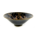 A Chinese porcelain bowl, of conical form with small foot rim, with very dark blue and brown speckle... 