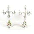 A pair of early 20th century Continental porcelain candelabra, in Rococo style, each with three scro... 