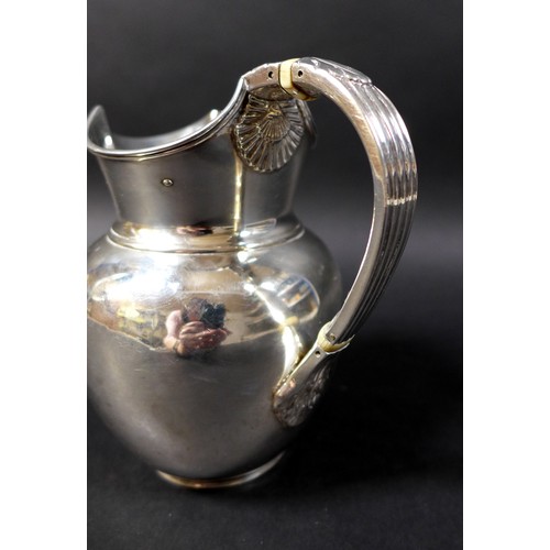 25 - A Victorian silver water jug, of ovoid form, with double hinged lid, reeded handle with acanthus lea... 