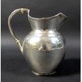 A Victorian silver water jug, of ovoid form, with double hinged lid, reeded handle with acanthus lea... 