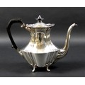 An Edward VII silver coffee pot, of fluted, baluster form, with ebonised finial and handle, raised o... 