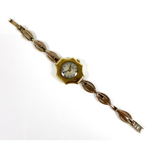 75 - An Art Deco 18ct gold cased lady's wristwatch, with cross shaped case, circular silvered dial, black... 