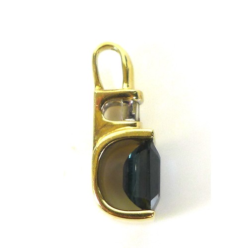 106 - A 14ct gold, synthetic sapphire, and diamond pendant, the royal blue emerald cut synthetic sapphire,... 