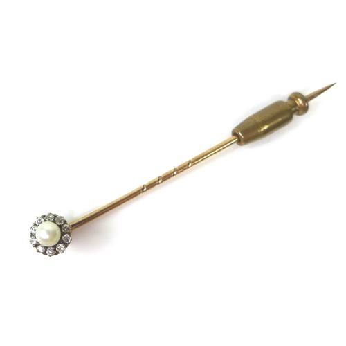 127 - A yellow metal stick pin, the removable head set with a cultured pearl surrounded by ten diamonds, 6... 