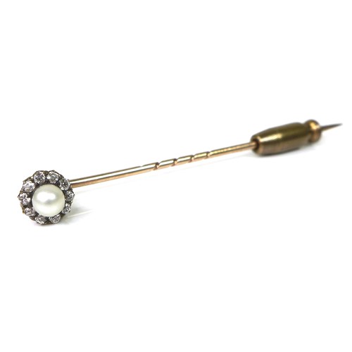 127 - A yellow metal stick pin, the removable head set with a cultured pearl surrounded by ten diamonds, 6... 