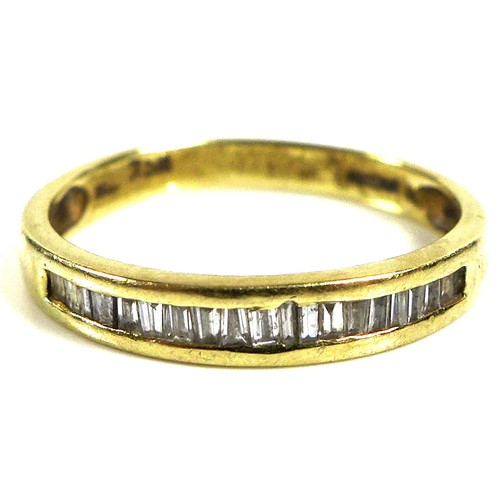 179 - An 18ct yellow gold and diamond set half eternity ring, the row of baguette cut stones approximately... 