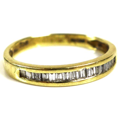 179 - An 18ct yellow gold and diamond set half eternity ring, the row of baguette cut stones approximately... 