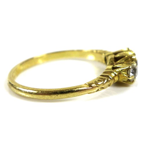 180 - A yellow gold three stone diamond ring, the central brilliant round cut stone of 3.4mm flanked by tw... 