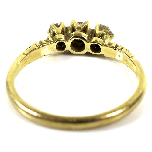 180 - A yellow gold three stone diamond ring, the central brilliant round cut stone of 3.4mm flanked by tw... 