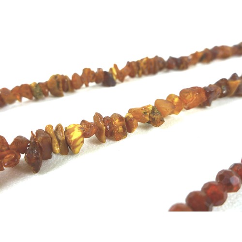 105 - A rough hewn amber necklace, 190cm long overall, 98.4g, together with a another amber style necklace... 