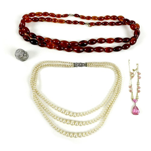 89 - A small group of jewellery, comprising a clear amber bead necklace, a vintage pink stone and gold pl... 