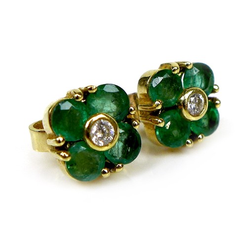 119 - A pair of gold, diamond and emerald earrings of quatrefoil flowerhead design, 6.4 by 6.4mm, 1.9g.