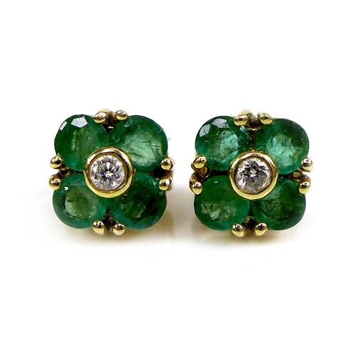 119 - A pair of gold, diamond and emerald earrings of quatrefoil flowerhead design, 6.4 by 6.4mm, 1.9g.