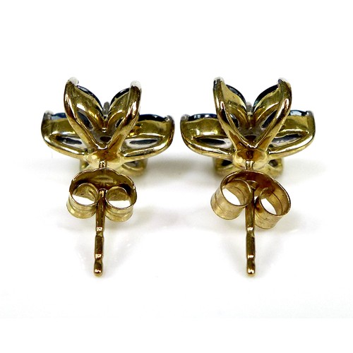 130 - A pair of 9ct gold, sapphire and diamond flowerhead stud earrings, six petalled design formed of mar... 