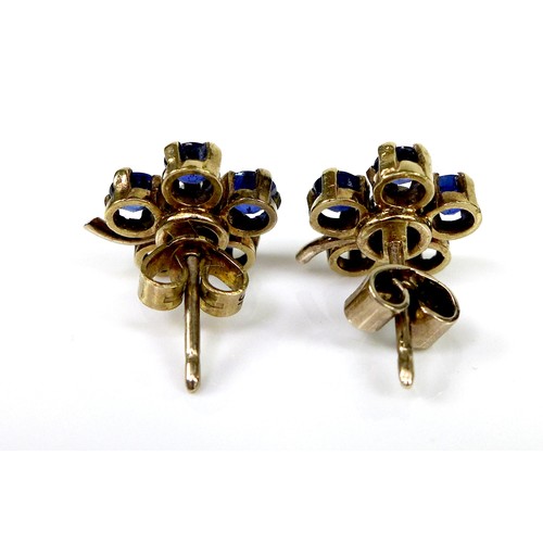 131 - A pair of gold, sapphire and diamond flowerhead earrings, formed of five round cut royal blue sapphi... 