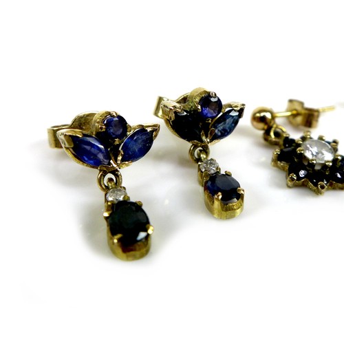 87 - Two pairs of gold and sapphire drop stud earrings, the first of flowerhead design with central white... 