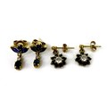 Two pairs of gold and sapphire drop stud earrings, the first of flowerhead design with central white... 