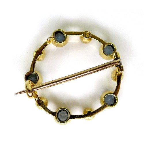 117 - A 15ct gold, sapphire and pearl brooch, of opal circle design with five beaded rubover set cornflowe... 