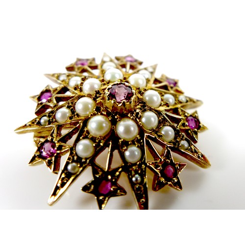 112 - A 9ct gold, ruby and pearl starburst brooch, 3.1cm diameter, 5.4g.