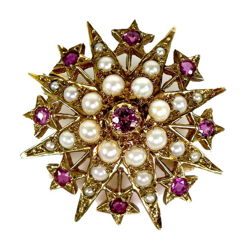 112 - A 9ct gold, ruby and pearl starburst brooch, 3.1cm diameter, 5.4g.