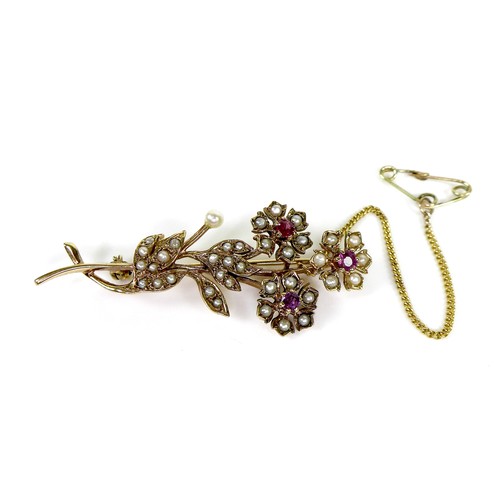 93 - A 9ct gold, pearl and ruby flower brooch, with safety chain, 5.3cm, 5.5g.