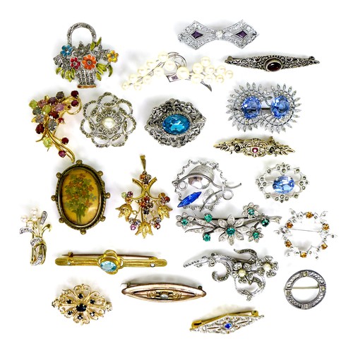 101 - A group of costume brooches, including examples set with coloured stones, paste, and faux pearls, an... 