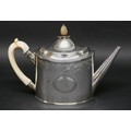 A George III silver teapot, of old oval shape, with pinapple form finial, engraved friezes, straight... 