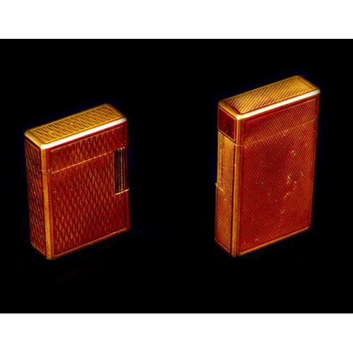 110 - Two retro Dupont gold plated lighters, the largest, 6cm long, with machine turned decoration, origin... 