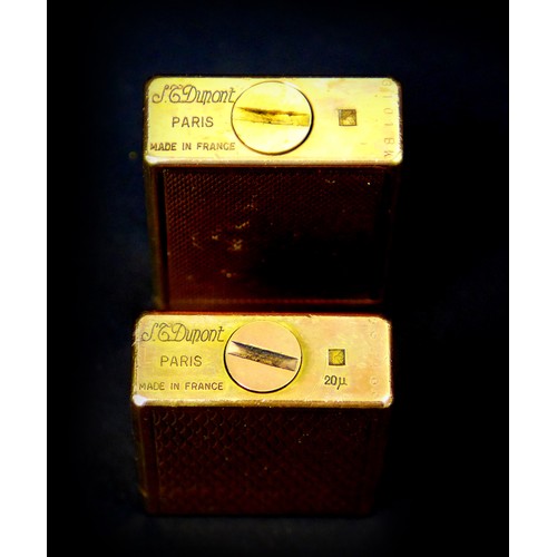 110 - Two retro Dupont gold plated lighters, the largest, 6cm long, with machine turned decoration, origin... 