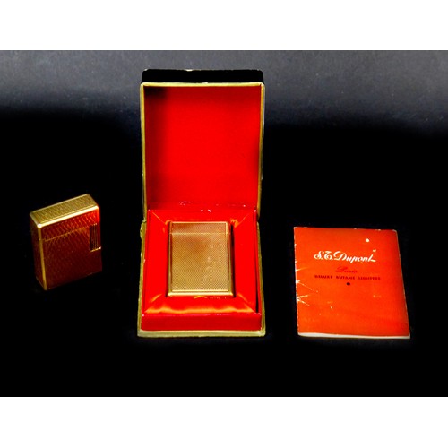 110 - Two retro Dupont gold plated lighters, the largest, 6cm long, with machine turned decoration, origin... 