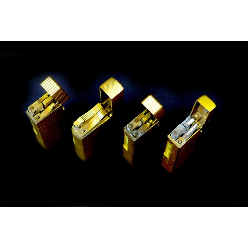 111 - Four retro gold plated Dunhill cigarette lighters, comprising a Dunhill 70 lighter, with original ca... 