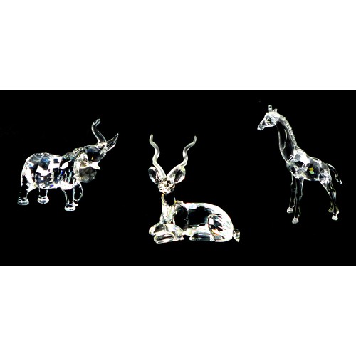 92 - Three Swarovski crystal ornaments, comprising a giraffe A7603 NR 000 002, 13.5cm high, with presenta... 