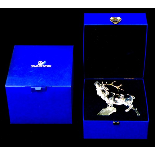 85 - A Swarovski crystal ornament of a stag with silvered antlers, A7608 000 004, 14cm high, with present... 