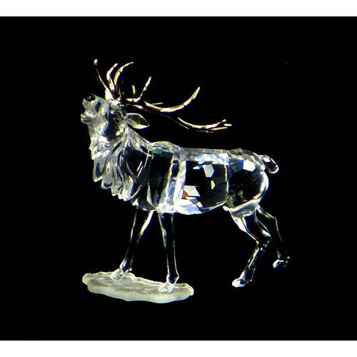 85 - A Swarovski crystal ornament of a stag with silvered antlers, A7608 000 004, 14cm high, with present... 